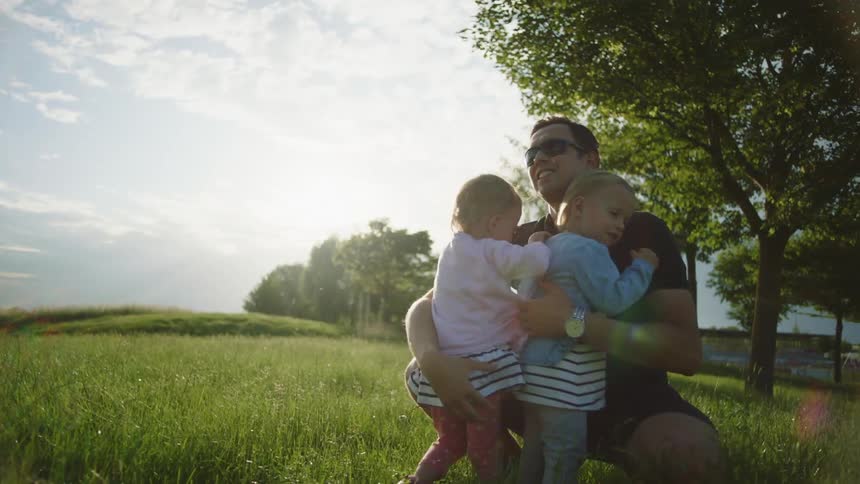 A child runs to her father for a hug