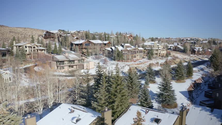Aerial view of houses and streets of a small town covered in white snow at winter