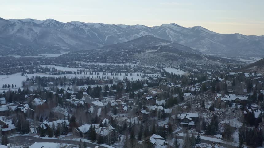 An aerial view of houses in a small town on a snowy winter day