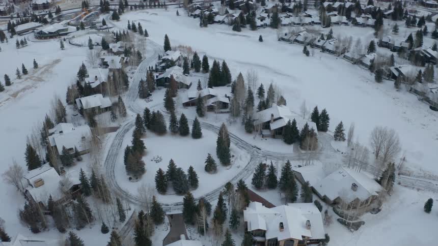 Aerial view of houses in a small town covered in white snow at winter