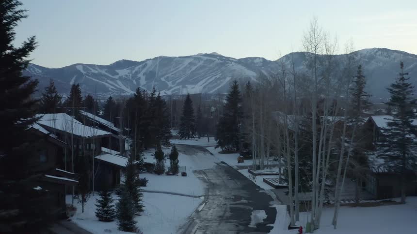 The small town by the mountains are covered with snow