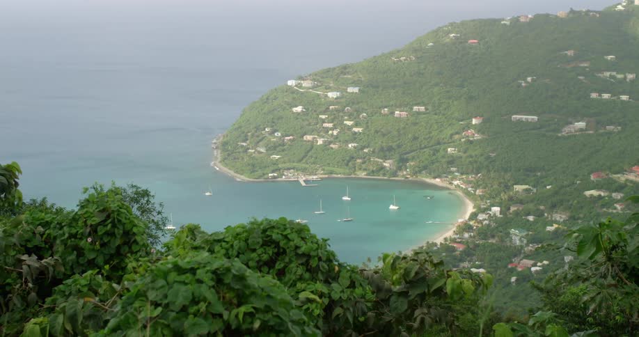 An aerial view of boats in the water just off the coast