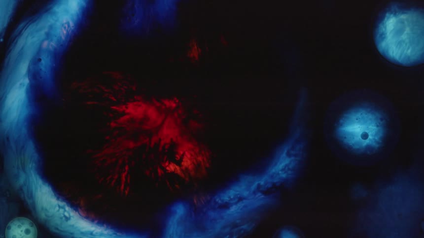 Blue and red patterns swirl together in between areas of black