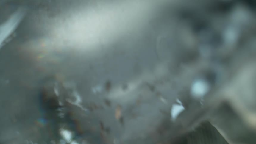 A blurred view of pigeons in a courtyard goes from upside down to right side up