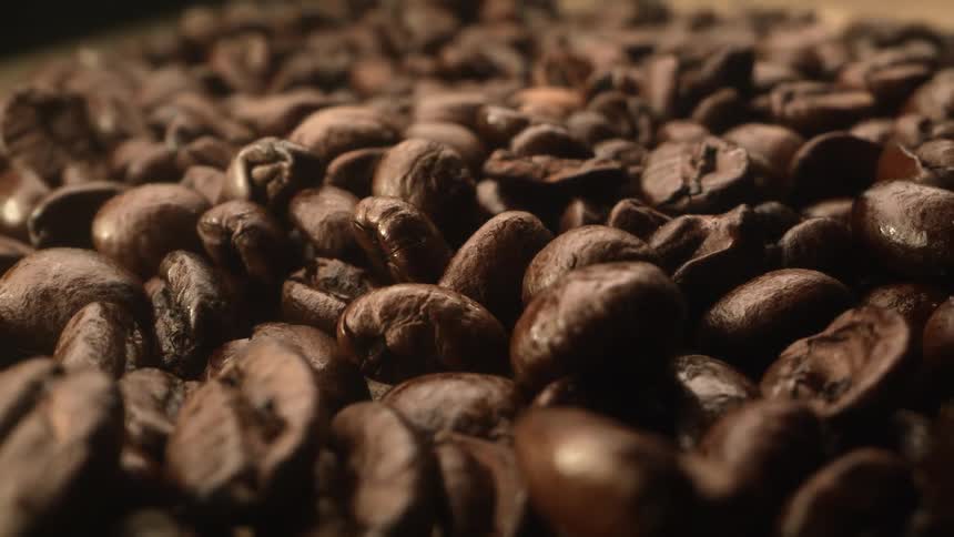 Close up of brown coffee beans bunched up together