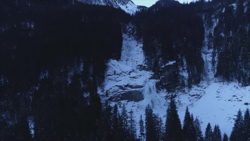 An aerial view of mountains with snow on them