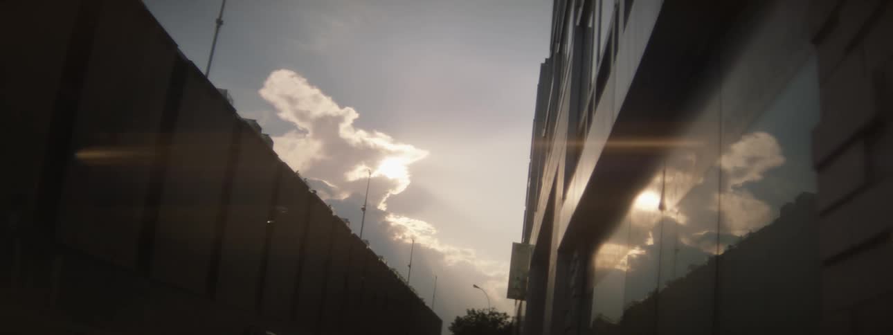 A cloudy sky reflected in windows on a city building