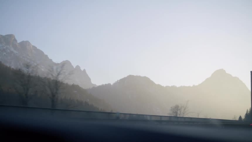 Silhouette of snow covered peaks of a mountain in the morning mist