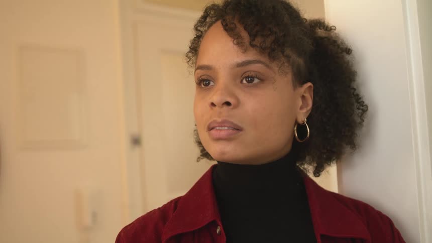 Young woma wearing a red jacket has a heated discussion in a room at home