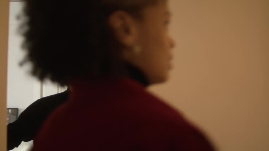 A man welcoming a woman into his home
