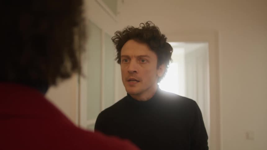 A man yells at a woman at home