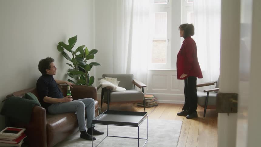 Young couple having an argument in the living room of a house
