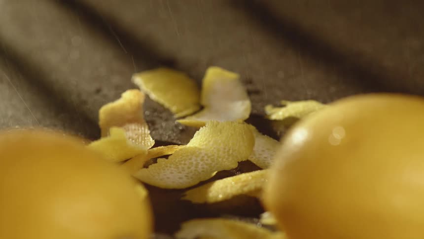 Lemon and lemon peels on the ground with rain