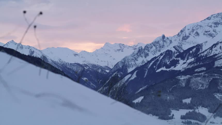 Snow covered slopes of a mountain at sunset