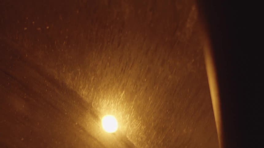 A view of street lights on a road through a car window