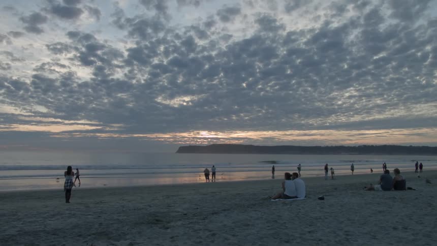People on a beach during sunset