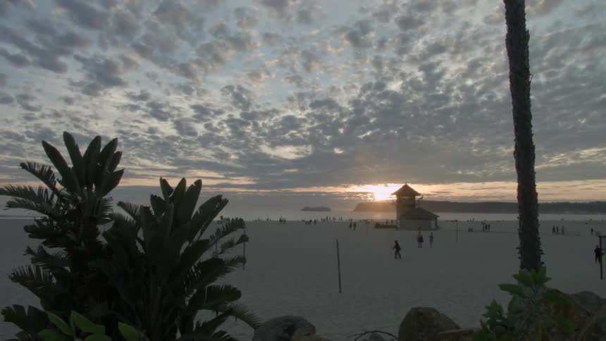 A crowded beach at sunset