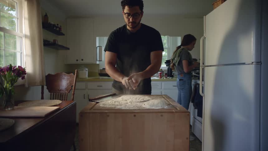 A man and woman cooking in a kitchen together