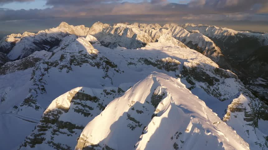 An aerial view of snow covered mountains