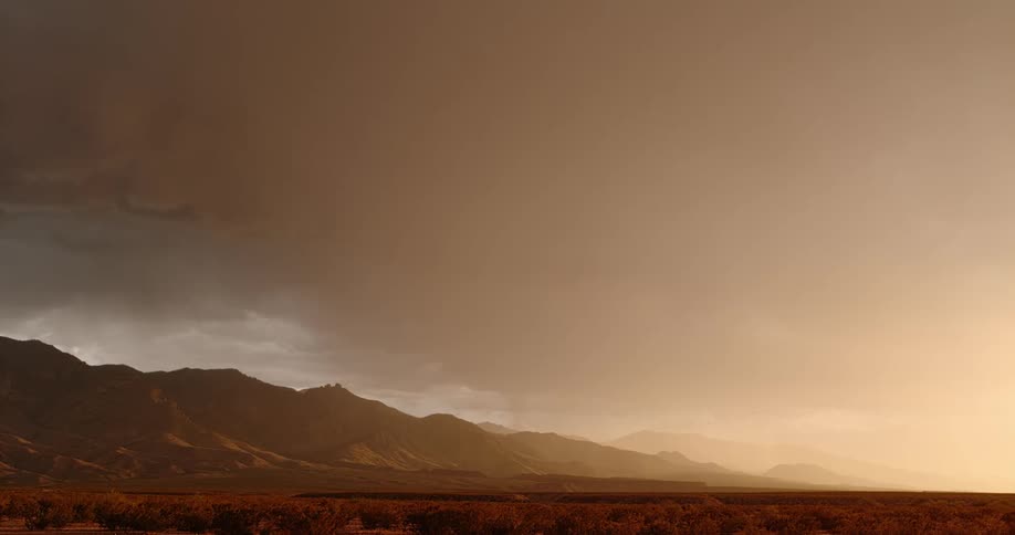Lightning bolts flash from dark storm clouds over mountains in an orange sky