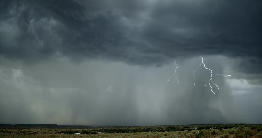 Lighting bolts striking a countryside during a thunder storm
