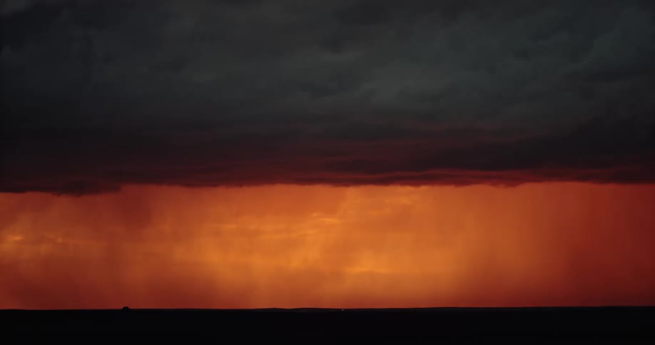A storm with lightning over a landscape with the sky and clouds in the background