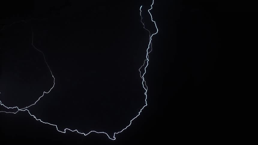 Lightning bolts flash and branch out in a dark sky