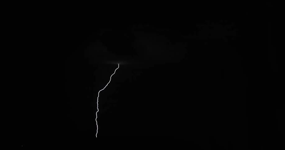 A storm is brewing in the sky at night