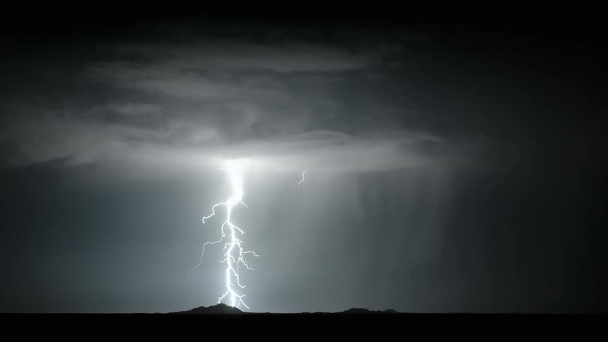 Lightning streaking arcs flashing and striking the ground at night
