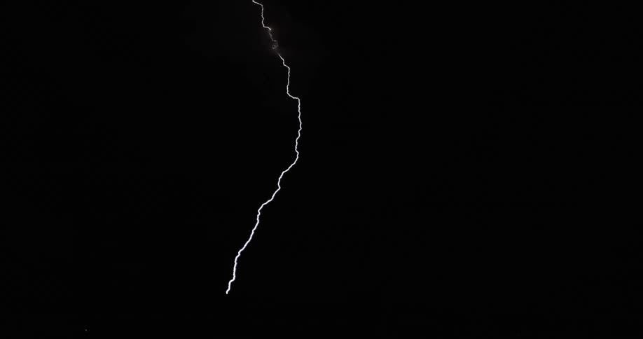Lightning streaking arcs flashing and striking the ground at night