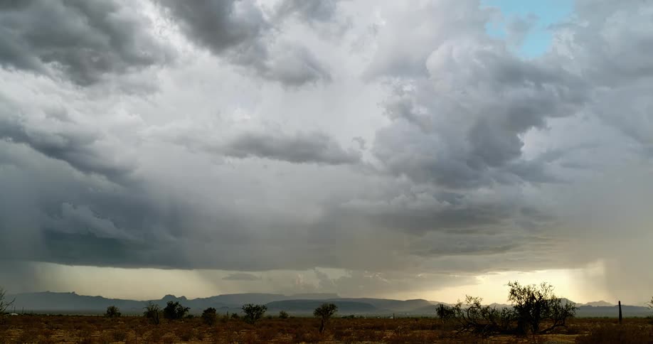 Lightning bolts flash and hit the ground in a rural area