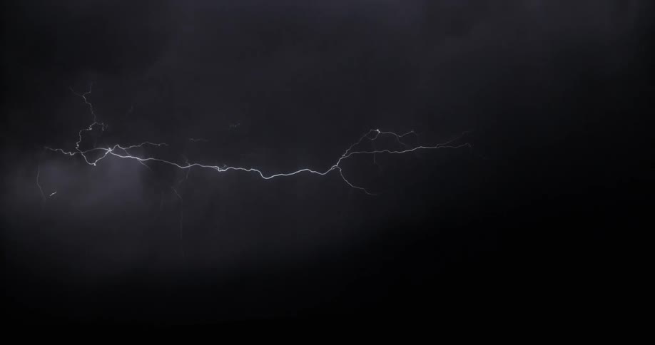 Lightning bolts flash and light up the dark sky