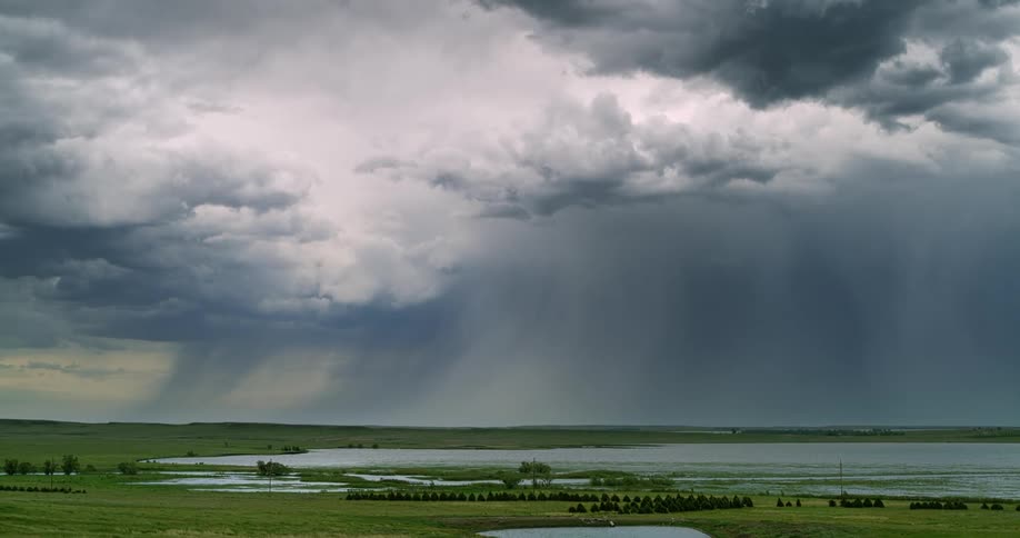 Lightning flashing during a thunderstorm over a rural lake