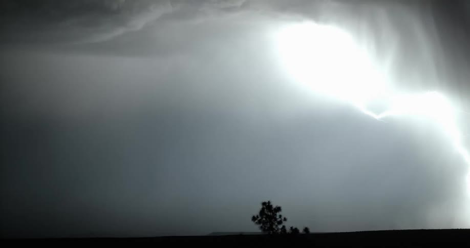 Several bolts of lightning shot downward from the sky during a powerful storm at night
