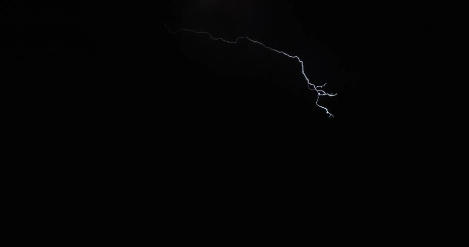 Lightning streaking arcs flashing and striking the ground at night