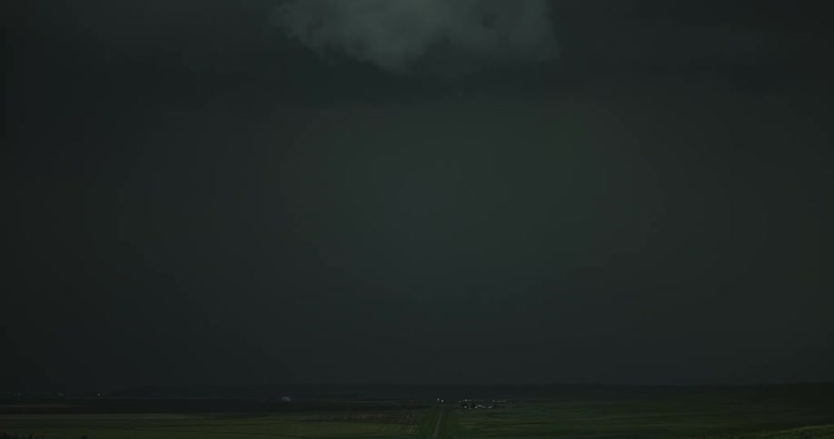 Lighting bolts flashing in the countryside at night