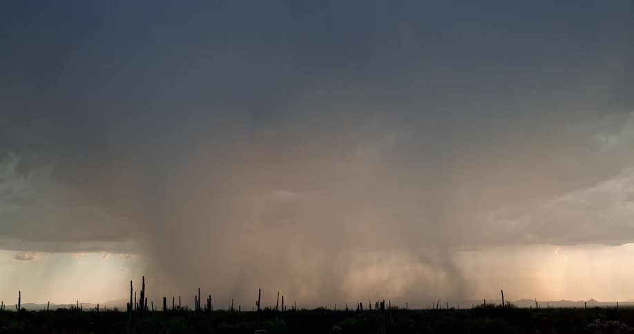 Lightning bolts flash and move around in a dark storm and hit the ground
