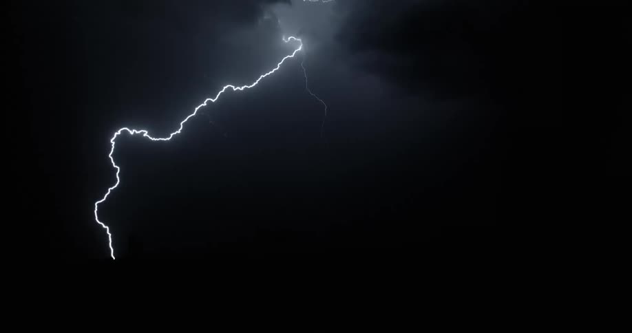 Lighting bolts flashing at night in the country during a storm