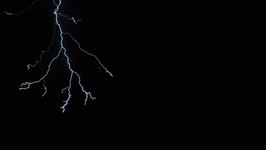 Lightning spreads throughout the cloudy nighttime sky over the countryside