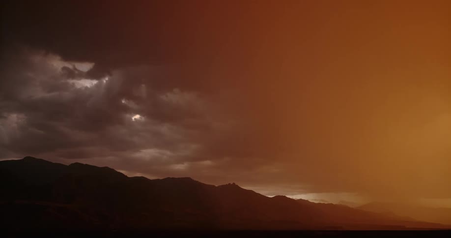 A slow motion view of lightning striking a mountain