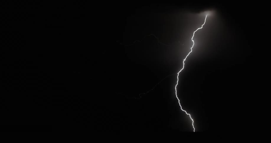 Lightning bolts flash and branch out lighting up a dark sky