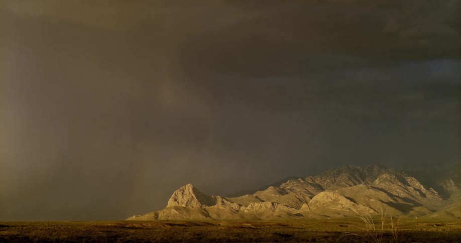 Lightning flashing above a mountain range during a thunderstorm