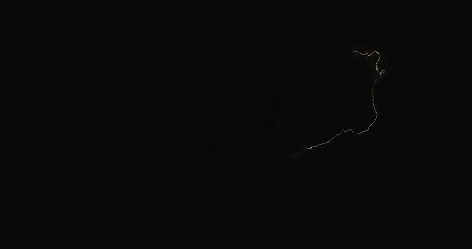 Lightning flashing in a dark cloudy sky during a thunderstorm