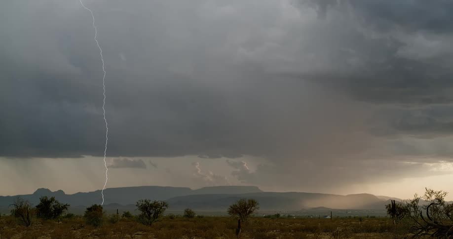 A view of lightning near some mountains
