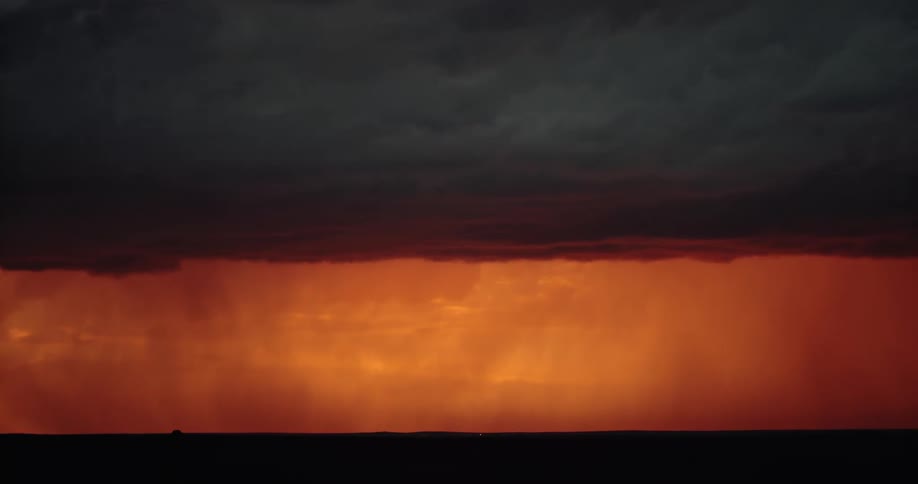 A storm with lightning over a landscape with the sky and clouds in the background