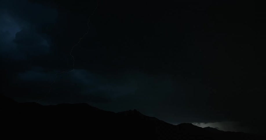 Lightning striking a mountain at night