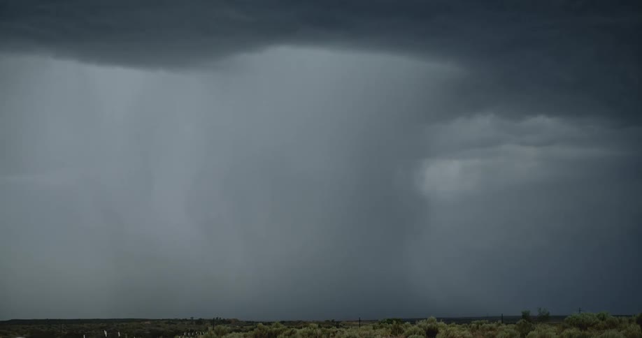 Lightning bolts from a dark storm cloud branch out and hit the ground