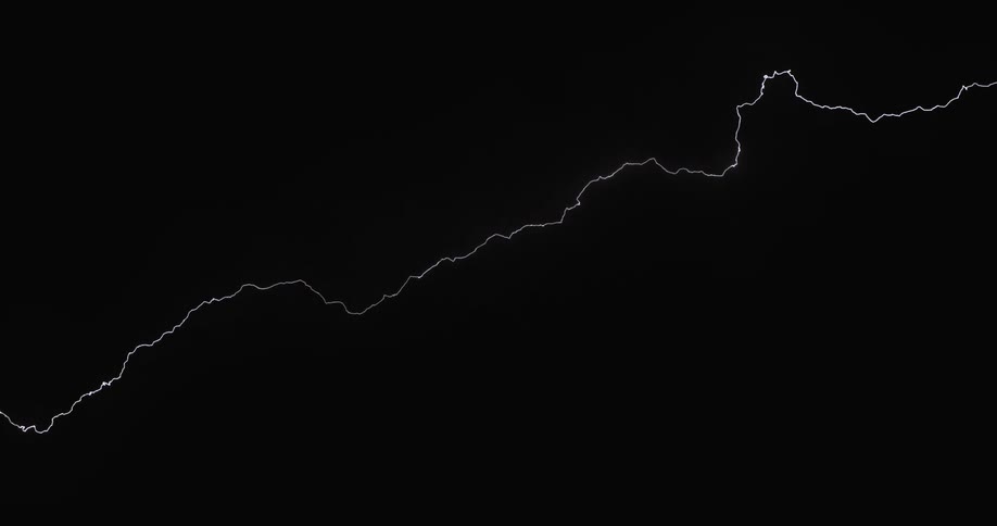 Lightning spreads throughout the dark clouds in the night sky