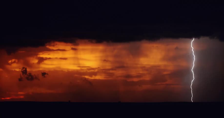 A storm with lightning with a landscape the sky and clouds in the background