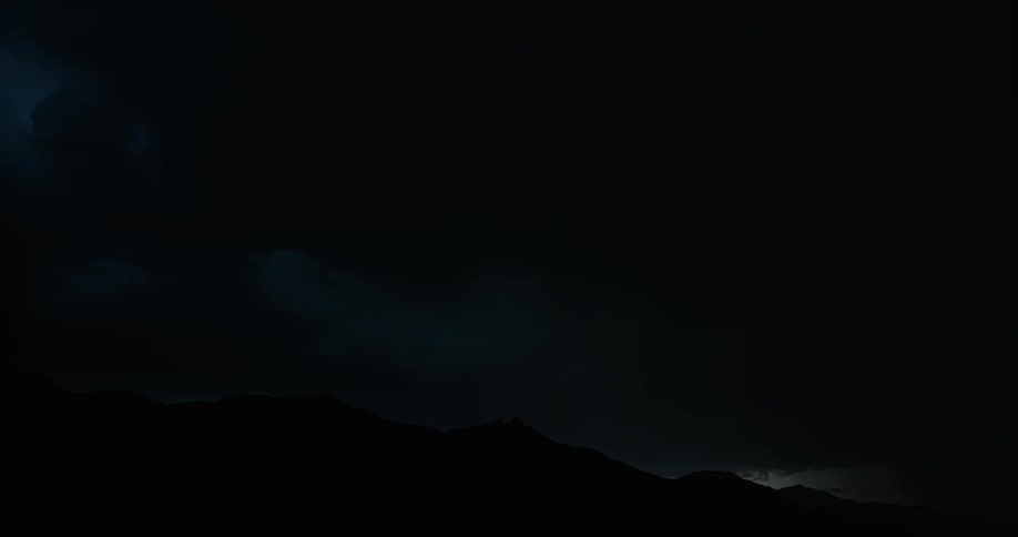 Lightning streaking arcs flashing and striking the ground at night